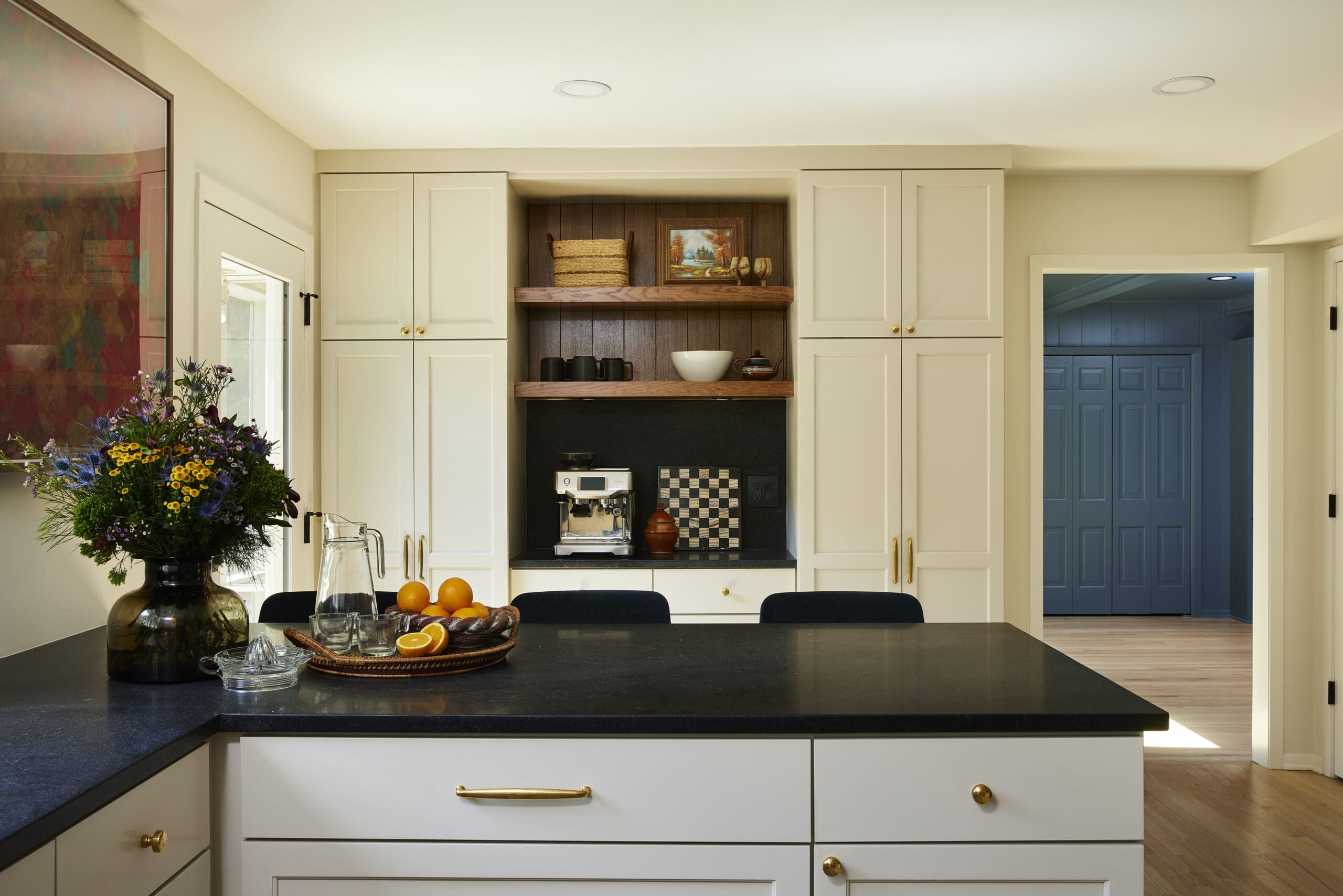 a minnesota home renovation project featuring an open floor plan kitchen with natural lighting and warm neutral decor with fresh flowers and an inviting atmosphere