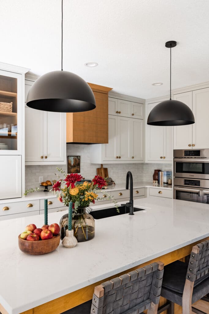 Minnesota kitchen renovation with alder wood range hood and custom gray cabinets, induction cooktop